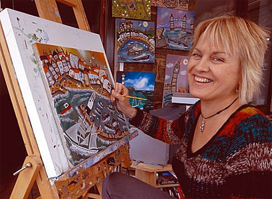 Illustrator Caroline Appleyard painting a Walcombe seaside scene at her easel